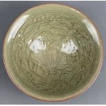 Chinese Yaozhou-type molded ceramic bowl, featuring lotus sprigs and fish reserves to the