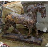 Primitive carved wood horse, rising on a rectangular base, 32"h x 36"l