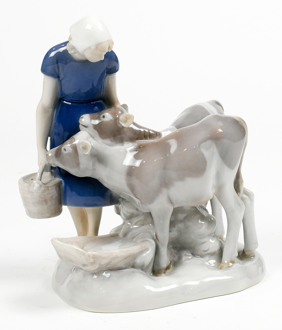 Bing and Grondahl figural sculpture depicting cows at the trough, standing beside a young girl