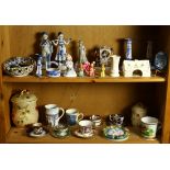 Two shelves of decorative art including Belleek, a Deruta plaque, associated tea cups, etc.