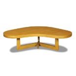 Mid-Century Modern boomerang table, having a contoured top above the conjoined legs, 14"h x 50.5"w x