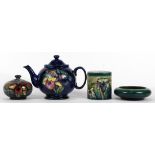 (lot of 4) Moorcroft ceramic group, each decorated with irises, consisting of a teapot, a lidded