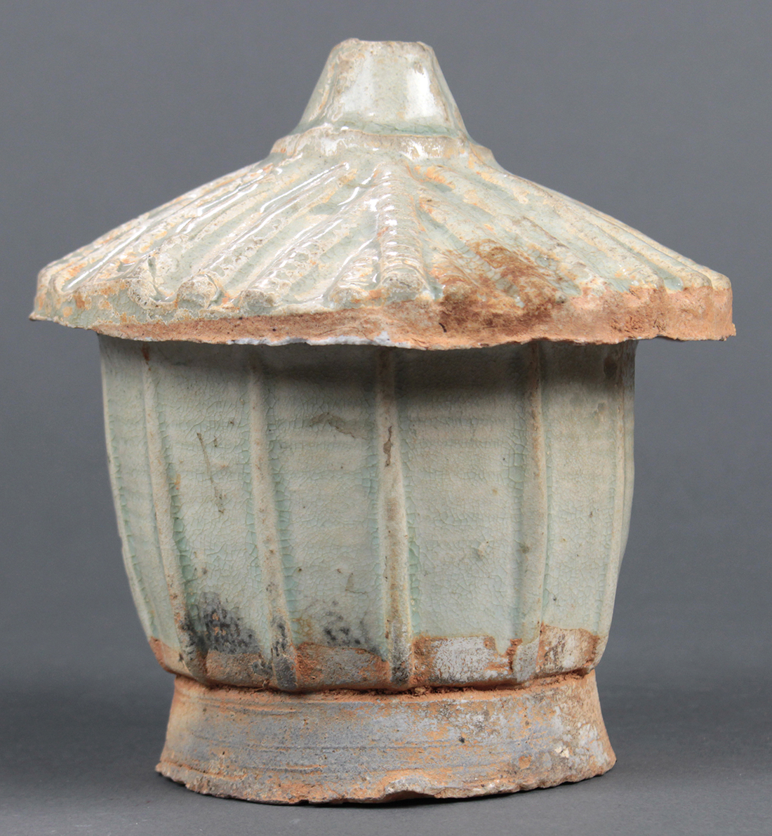 Chinese celadon glazed covered jar, in the form of a granary, with a thatched roof form lid and