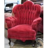 English Turkish style armchair, circa 1860, having a shaped tufted back, and rising on short