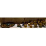 One shelf of Russian lacquer tableware including egg cups, a serving plate, utensils, etc.