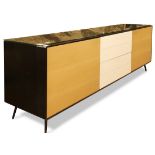 Contemporary mixed wood sideboard, having an ebonized case with blonde doors flanking the