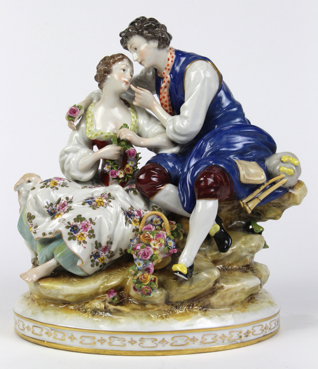 Continental porcelain sculpture depicting a courting couple, depicted seated on a rock form, the