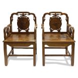 Pair of Chinese hardwood armchairs, each of the back splats is a roundel carved with peaches, the