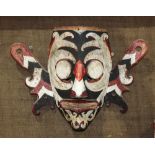 Dayak carved wood mask, Borneo, having round eyes and oversized ears, painted white, red and