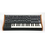 Moog Subsequent 37 analog synthesizer in box, with a control panel having 40 knobs and 74
