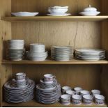 Three shelves of Limoges porcelain comprising a modern Bernardaud Ponidichery dinner service with