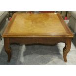 Modern square cocktail table, having a burl top and rising on cabriole legs, 17"h x 35" square