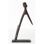 Melanesian implement or dance stick with head carved integrally atop, probably Papua New Guinea,