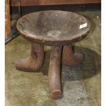 Aftrican carved wood tripartie stool, having a round concave seat, 13"h x 16"dia.