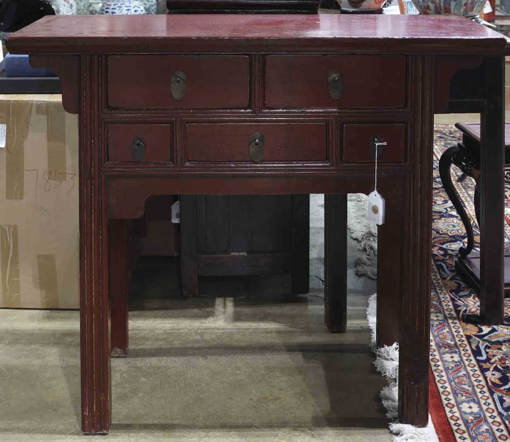 Chinese red lacquered table, fronted with five drawers, and raised on rectangular supports, 40.5"h