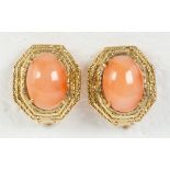 Pair of coral and 14k yellow gold earrings Featuring (2) oval coral cabochons, measuring