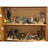 Two shelves of vintage cast iron, brass and other metalware items including animal figures,