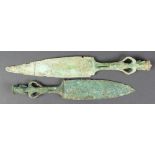 (lot of 2) Dongson bronze daggers, each of the handles of anthropomorphic form with large earrings