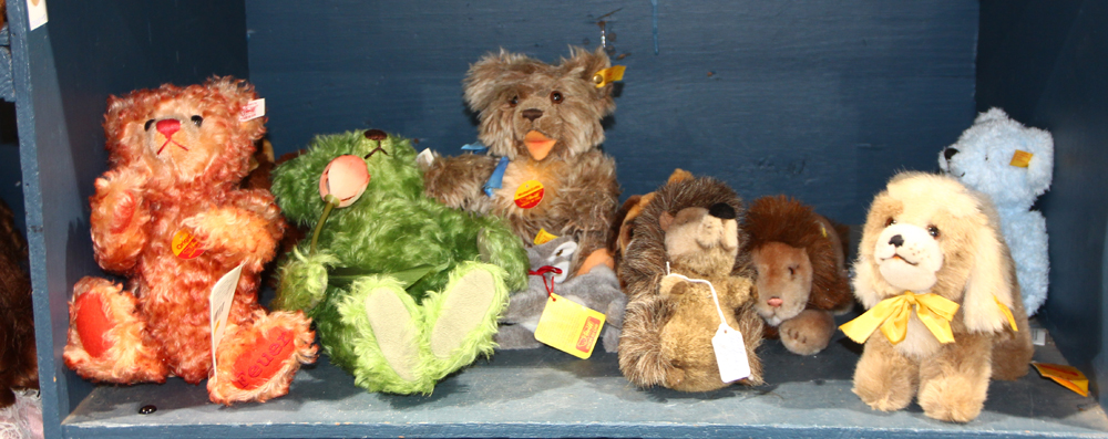 One shelf of Steiff animals, including "Mohair Zotty," together with lions, dogs, and red and