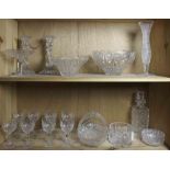 Two shelves of cut glass , comprising three modern Bohemian bowls, a bud vase and a basket; an
