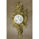 Rococo style gilt wall clock, having a floral decorated case, the dial with Roman and Arabic