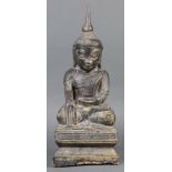 Southeast Asian wooden Buddha, seated in dhyanasana with hand in bhumisparsha mudra, above a