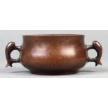 Chinese patinated bronze censer, with a low slung body flanked by a pair of fish form handles, the