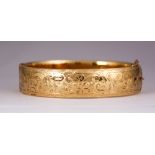 9k gold-filled bracelet The 9k gold-filled, hinged bangle, measures approximately 15.7 mm in width