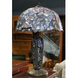 Tiffany style leaded glass table lamp, having a floral and spider web decorated shade above the