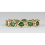 Emerald and 18k yellow gold eternity band