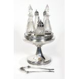 Silver plate cruet set, having six etched glass bottles, on a rotating round tray, 16"h