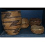 One shelf of baskets, including a Senegalese exmple, largest: 15"h x 12"dia.