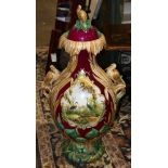 Monumental European scenic decorated lidded majolica vase circa 1860, having floral and applied bird