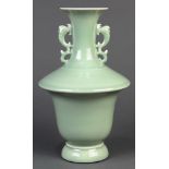 Chinese celadon glaze porcelain vase, a trumpet neck flanked by zoomorphic handles, with a flared