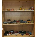 Three shelves of vintage and cast iron toys, including cars, airplanes, birds, animals, etc.