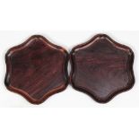 Pair of Chinese wooden trays, of hexagonal section with a conforming rim, raised on small