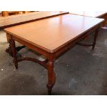 Mahogany table, the rectangular top rising on spooled legs conjoined by a lower stretcher, 30"h x