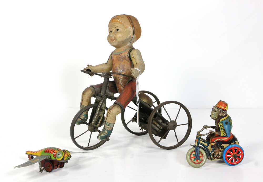 (lot of 3) Vintage lithographic tin toys including a girl on tricycle, a monkey riding a tricycle