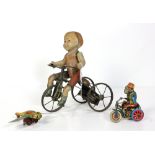 (lot of 3) Vintage lithographic tin toys including a girl on tricycle, a monkey riding a tricycle
