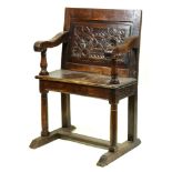 Jacobean oak armchair, having a paneled back, above scrolled arms, rising on columnar supports