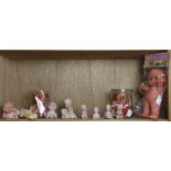 One shelf of Kewpie Dolls, comprising seven bisque dolls in various poses, three Cameo character