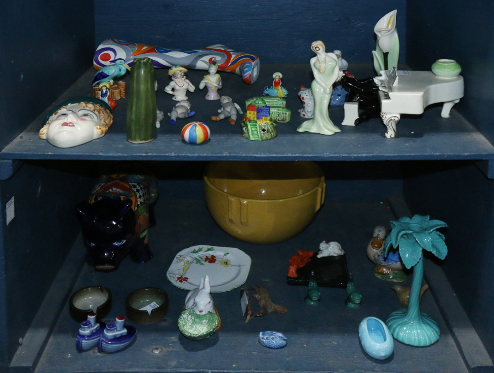 Two shelves of vintage porcelain and china table articles, consisting of salt and pepper shakers