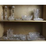 Two shelves of cut glass, comprising two vintage brilliant cut berry bowls and three cruet dishes; a