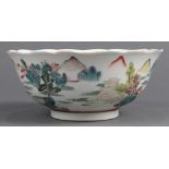Chinese enameled porcelain bowl, with a foliate rim featuring pavilions along the river landscape,