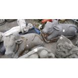 (lot of 2) Indian stone sculptures of Nandi, each in the form of a recumbent ox, largest approx: