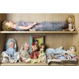 Two shelves of dolls comprising a large AE doll in a blue fancy dress 29"h.; two Italian Fugca