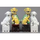 (lot of 4) Two pairs of Chinese porcelain fu-lions: one pair blanc de chine and the other set with a