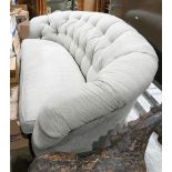 Contemporary Chesterfield style sofa, having a tufted back with a single loose cushion, and rising