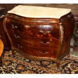 Continental marquetry decorated commode, having a variegated top above the three drawer case of