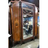 Louis XVI style marquetry decorated three door armoire circa 1900, having an inlaid case with